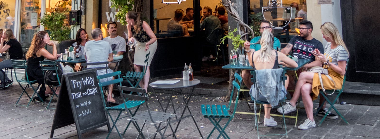 Restaurant customers eating outside.