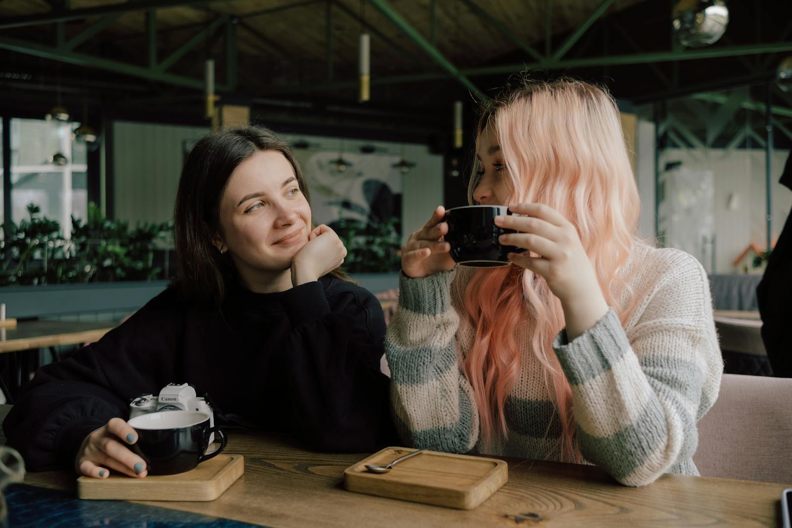 Two friends enjoying brunch for Galentine's Day at a restaurant. 
