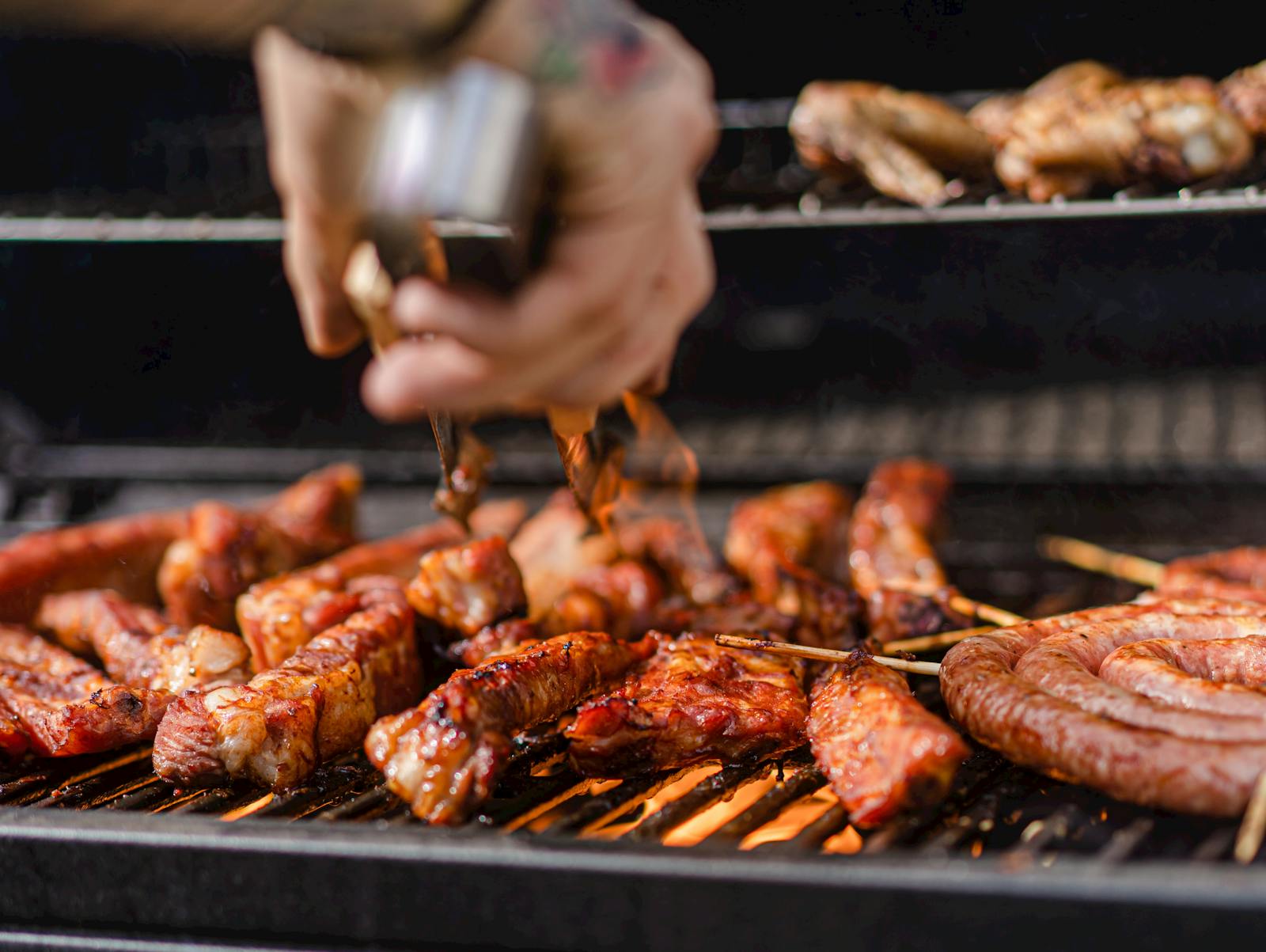 A chef cooking in a BBQ food truck. 