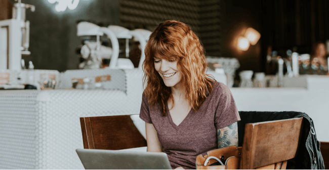Image of a woman working on her laptop in a restaurant